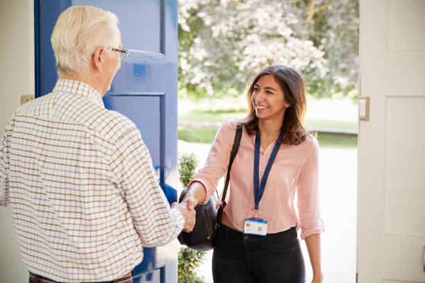 istock Senior man greeting young woman making home visit 849177802