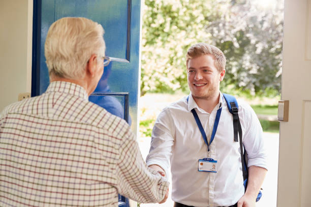 istock Senior man greeting male care worker making home visit 849177938