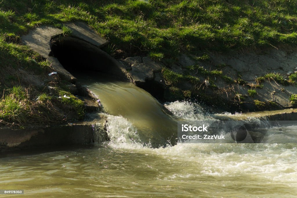 Water pollution Sewerage system, dirty water discharged into river. Sewage Stock Photo