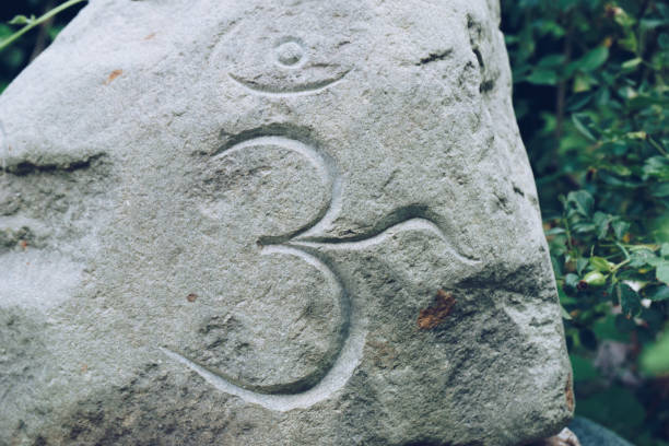 istock Om Symbol writtng on a big stone 849178384