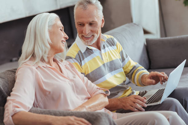 istock Positive loving aged couple using their laptop at home 849180734