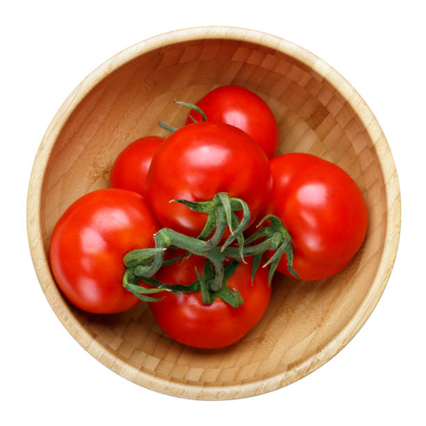 istock Tomatoes in wooden bowl isolated on white background. Top view. 849181502