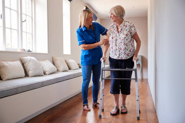 istock Nurse helping senior woman use a walking frame 849182232