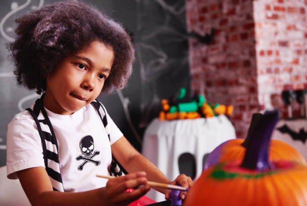 istock She clever at painting a pumpkin 849182272