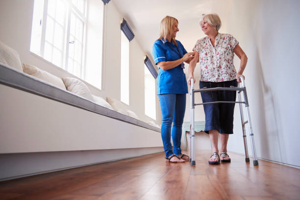 istock Nurse helping senior woman use a walking frame, full length 849182328