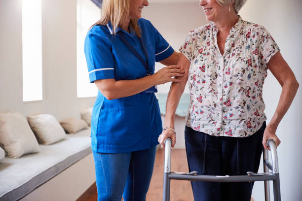 istock Nurse helping senior woman use a walking frame, mid section 849182334