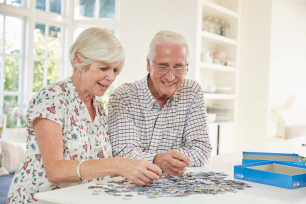 istock Senior couple doing a jigsaw puzzle at home 849187118