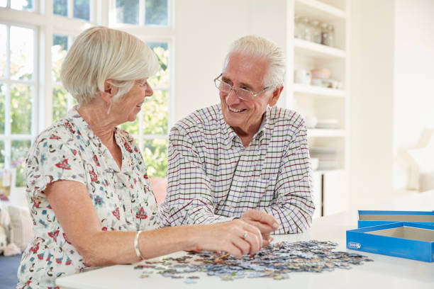 istock Senior couple doing a jigsaw puzzle at home 849187120