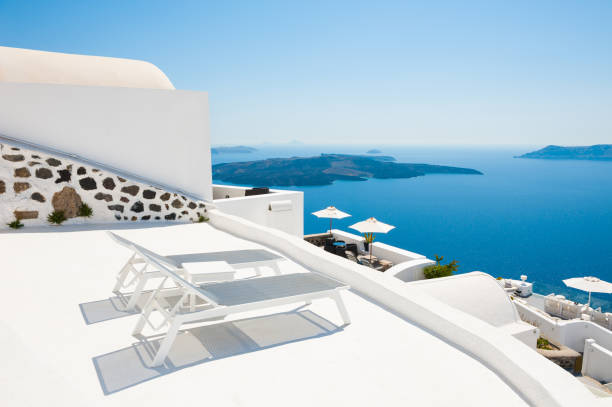istock Two sunbeds on the terrace. Santorini island, Greece. 849188876