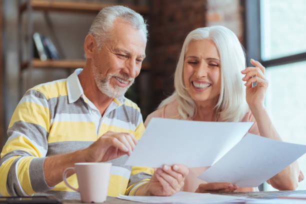 istock Positive aged couple being involved in paperwork at home 849189054
