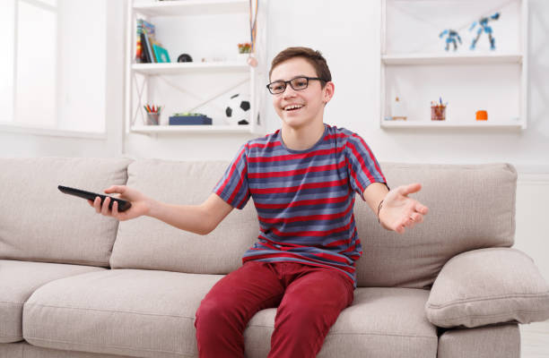 istock Cheerful boy watching funny TV show at home 849189166