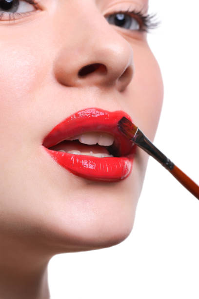 istock Make-up artist apply lipstick with brush, beauty concept 849193082