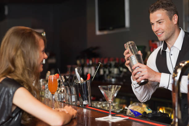 istock Handsome bartender serving cocktail to beautiful woman 849193354