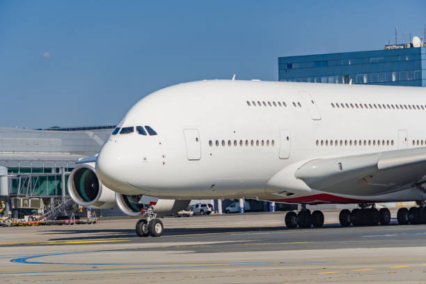 White airplane parked to terminal in airport.