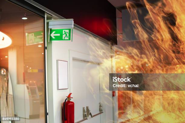 Emergency Fire Exit Sign And Fire In Shopping Mall Stock Photo - Download Image Now