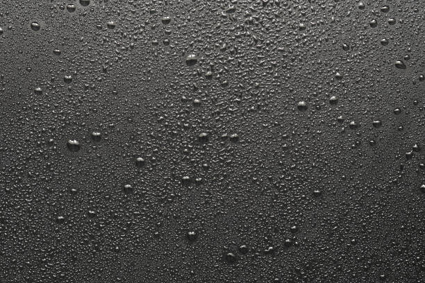 istock Drops of water on a black surface. The condensate. Top view. Free space. 849197600