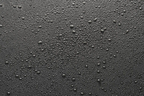 istock Drops of water on a black surface. The condensate. Top view. Free space. 849202240