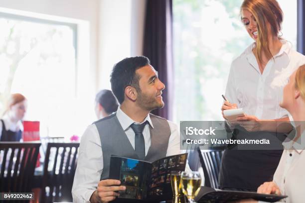 Handsome Businessman Ordering Food From Waitress Stock Photo - Download Image Now - 18-19 Years, 20-24 Years, 20-29 Years