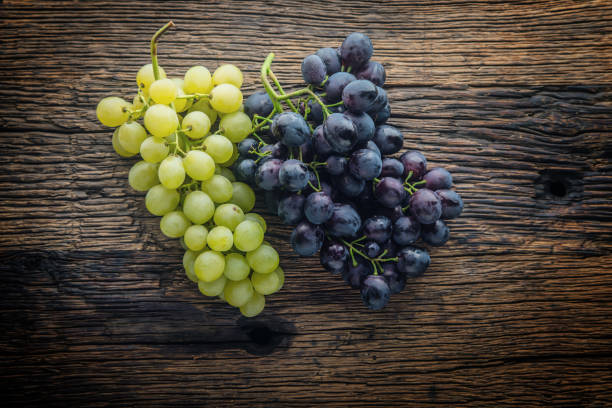 istock Grape. Bunch of multicolored grapes on rustic wooden table 849203646