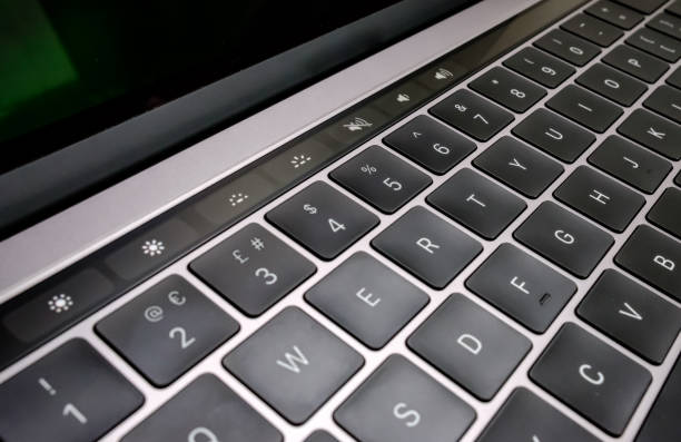 istock Close-up view of a laptop computer keyboard and toucher technology, from a leading US computer manufacturer, showing the keyboard layout and touch bar facility strip. 849203966