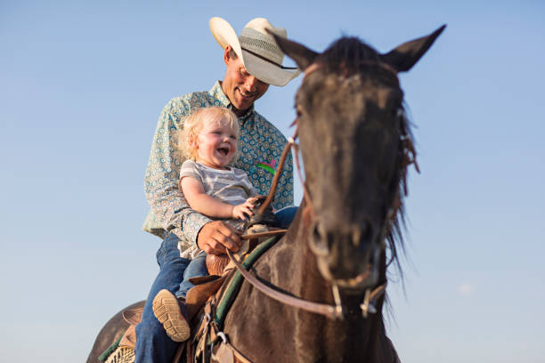 father with his baby daughter having a great time horse riding - teaching child horseback riding horse imagens e fotografias de stock