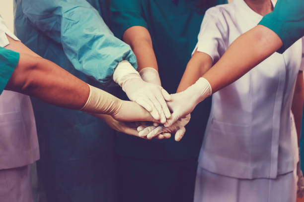 Doctors and nurses coordinate hands. Concept Teamwork stock photo