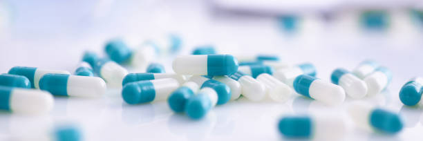 tabletki rozrzucone na stole laboratorium farmaceutycznego - cirrocumulus zdjęcia i obrazy z banku zdjęć