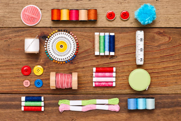 istock Overhead flat lay of various sewing items arranged on wood 849208672