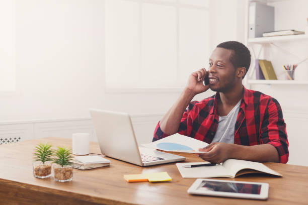 istock Young black businessman read documents in modern white office 849210744