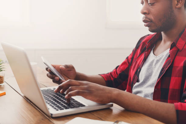 istock Black businessman in casual office, work with laptop 849210974