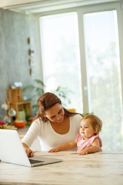 istock Mom and baby working on a computer 849212018