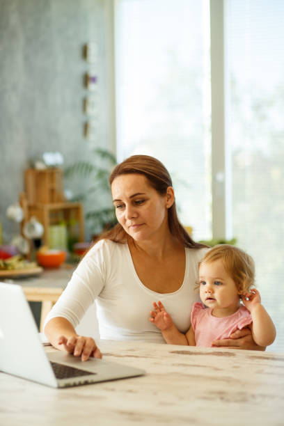 istock Mom and baby working on a computer 849212022