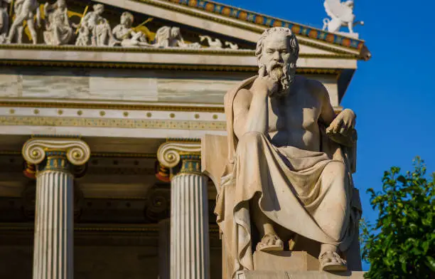Close-up statue of the Greek philosopher Socrates on the background of classical columns