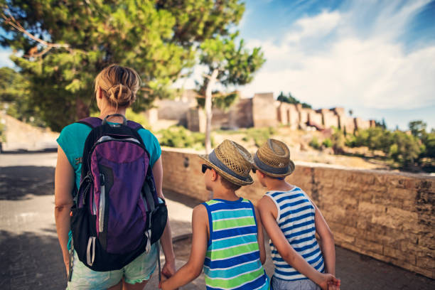 Mother and sons sightseeing city of Malaga, Andalusia, Spain Mother with little boys tourists sightseeing city of Malaga in Andalusia, Spain. 

 alcazaba of málaga stock pictures, royalty-free photos & images