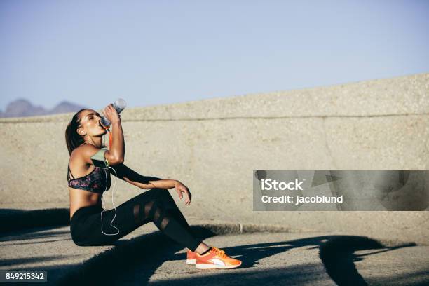 Healthy Woman Drinking Water After Exercising Stock Photo - Download Image Now - Exercising, Drinking, Sport