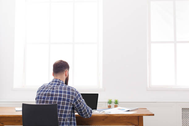 istock Young relaxed businessman with laptop in modern white office 849215520