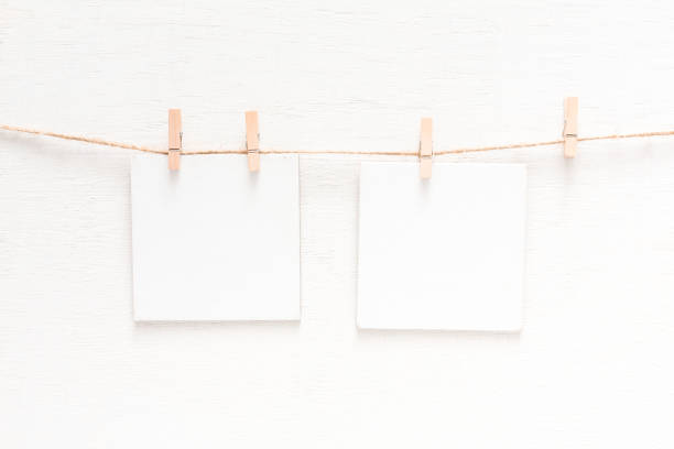 istock White blank cards on rope, light wall background 849217128