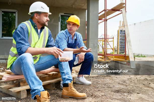 Taking Break From Work Stock Photo - Download Image Now - Construction Worker, Discussion, Talking