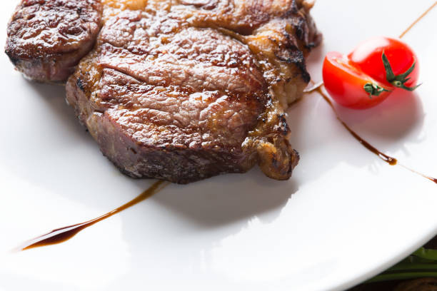 istock Rib eye steak on white plate closeup 849226000