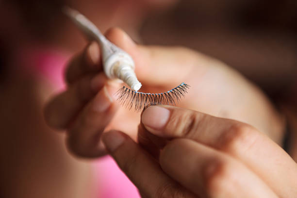 Woman apply glue with False Eyelashes. False eyelashes, Make-up, Professional occupation, Human hand, Glue, Apply false lashes stock pictures, royalty-free photos & images