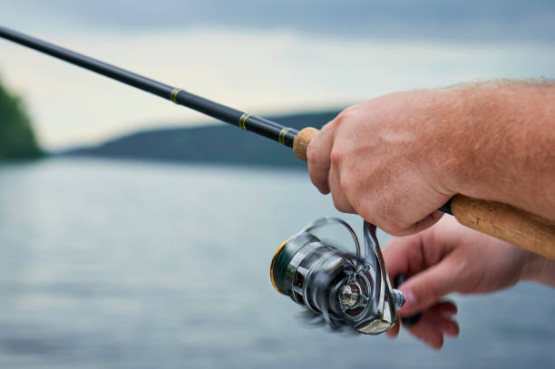 istock men hands kept spinning on the background of the river 849230990