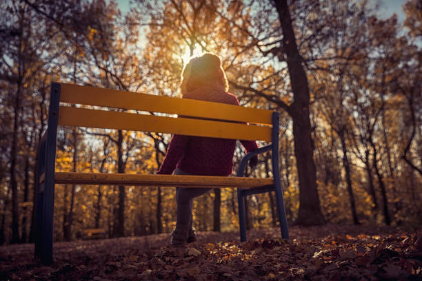 istock woman sitting on a bench 849231236