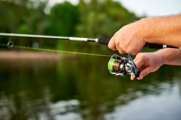 istock men hands kept spinning on the background of the river 849234292