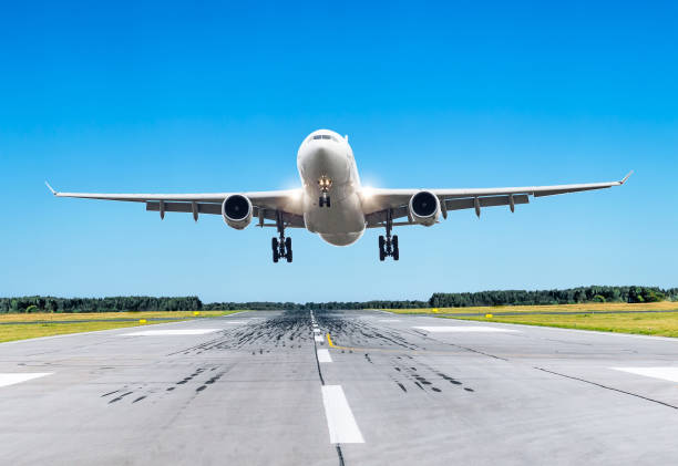 istock Passenger large airplane fly over the runway in good weather 849234450
