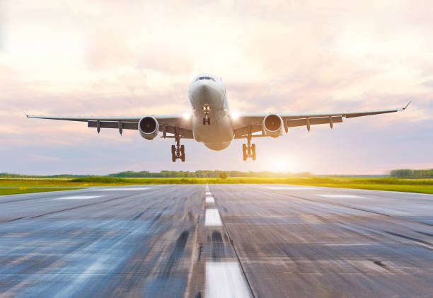 istock Passenger airplane landing at sunset on a runway 849234466