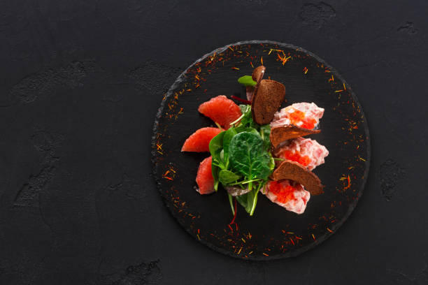 gourmet seafood snack on black plate top view - plank bread caviar close up imagens e fotografias de stock