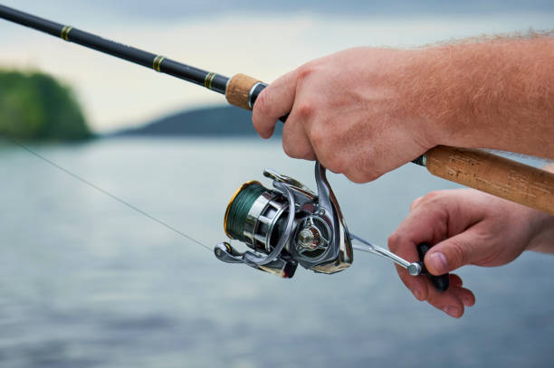 istock men hands kept spinning on the background of the river 849238072