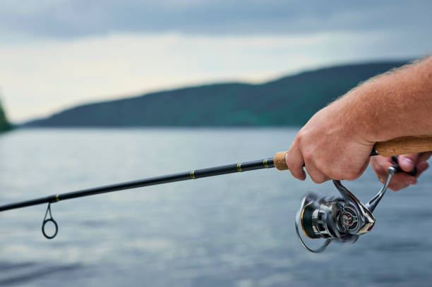 istock men hands kept spinning on the background on the evening river 849238224