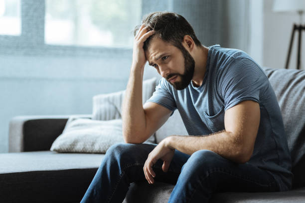 istock Sad gloomy man holding his forehead 849238664