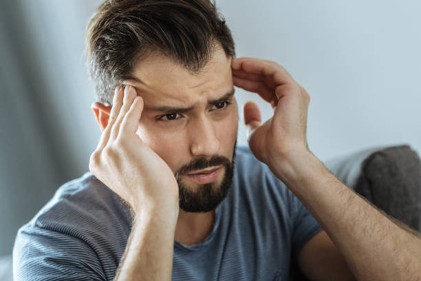 istock Cheerless unhappy man massaging his temples 849239346